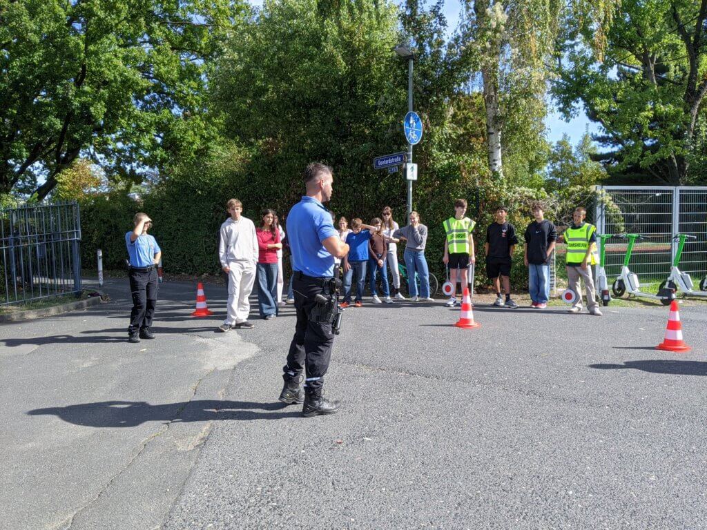 Elèves qui sont formés par la police de francfort sur le main à la gestion de la circulation sur un parking devant l'école du lycée français international Victor Hugo de Francfort sur le main en Allemagne.